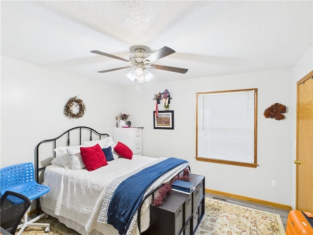 529 SE Dd Hwy, Warrensburg, MO 64093 - bedroom with wood finished floors, a ceiling fan, and a textured ceiling