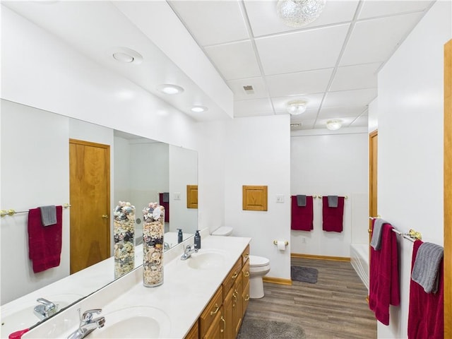 529 SE Dd Hwy, Warrensburg, MO 64093 - bathroom with a paneled ceiling, double vanity, and wood finished floors