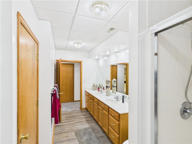529 SE Dd Hwy, Warrensburg, MO 64093 - full bathroom with double vanity, a paneled ceiling, wood finished floors, and a shower