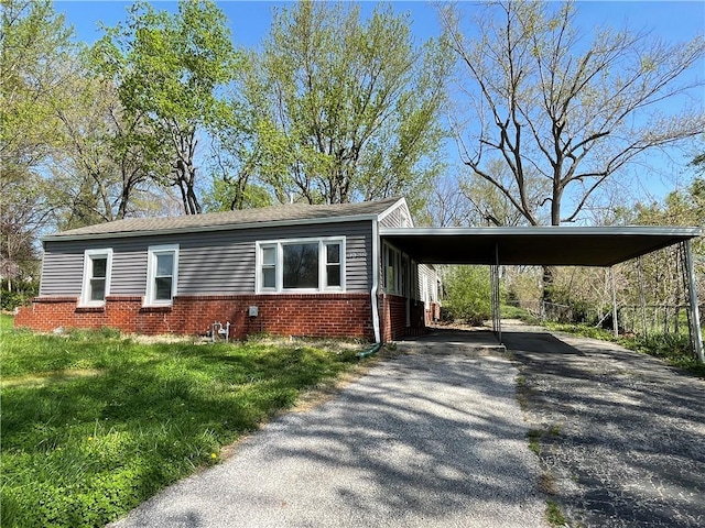 13508 E Silver Ln, Independence, MO 64050 - view of front of property featuring brick siding, driveway, and an attached carport