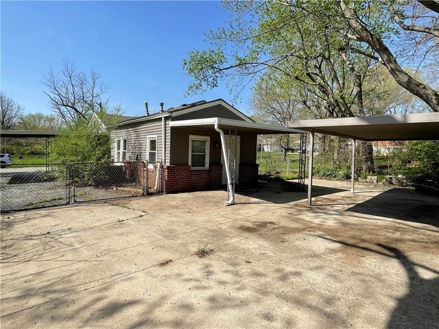 13508 E Silver Ln, Independence, MO 64050 - view of side of property with a gate, driveway, and brick siding