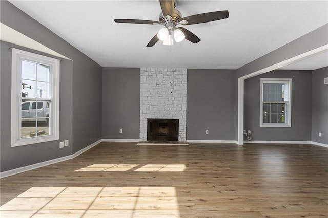 14011 Dunbar Ct, Grandview, MO 64030 - unfurnished living room with wood finished floors, a fireplace, and ceiling fan