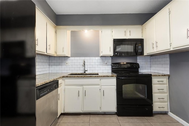14011 Dunbar Ct, Grandview, MO 64030 - kitchen featuring black appliances, light tile patterned floors, tasteful backsplash, and white cabinetry