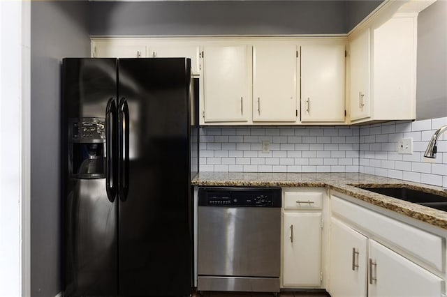 14011 Dunbar Ct, Grandview, MO 64030 - kitchen featuring black fridge, stainless steel dishwasher, tasteful backsplash, white cabinetry, and light stone countertops