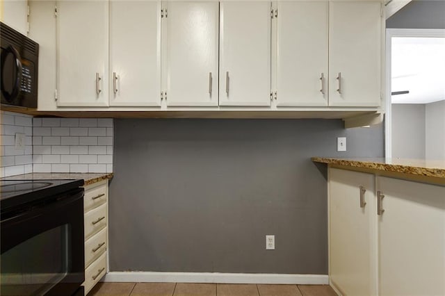 14011 Dunbar Ct, Grandview, MO 64030 - kitchen with black appliances, tasteful backsplash, light stone countertops, and white cabinets