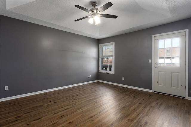 14011 Dunbar Ct, Grandview, MO 64030 - empty room featuring a textured ceiling, a ceiling fan, and dark wood-style floors