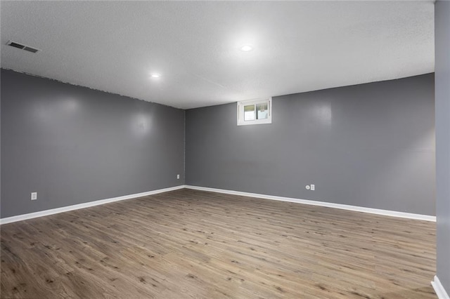 14011 Dunbar Ct, Grandview, MO 64030 - empty room featuring wood finished floors, recessed lighting, and a textured ceiling