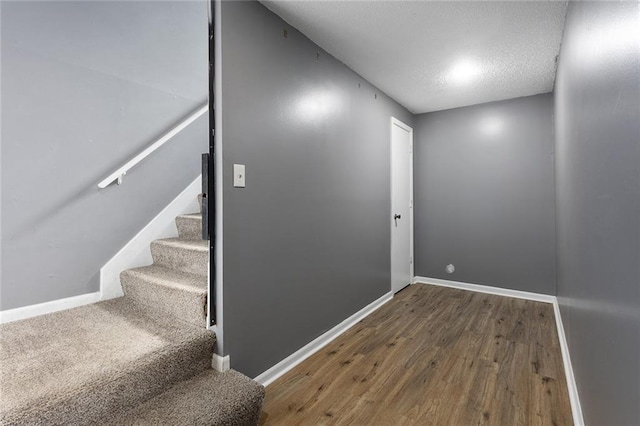 14011 Dunbar Ct, Grandview, MO 64030 - stairway with wood finished floors and a textured ceiling