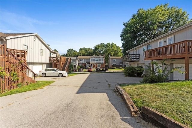 14011 Dunbar Ct, Grandview, MO 64030 - view of asphalt road with a residential view and stairs