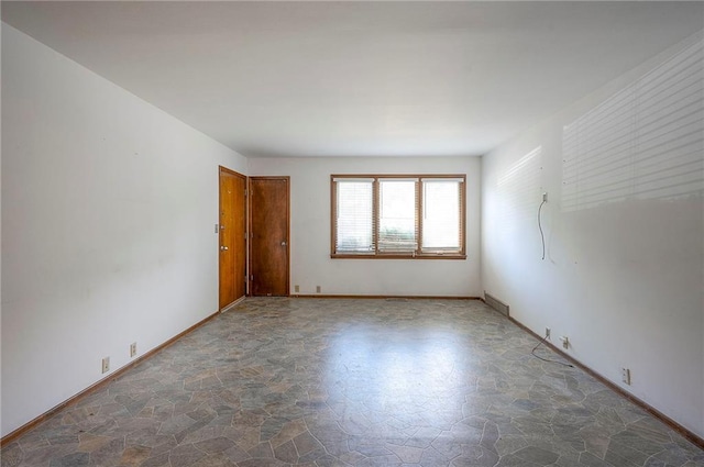 462 W 104th St Unit A, Kansas City, MO 64114 - spare room featuring stone finish floors and baseboards