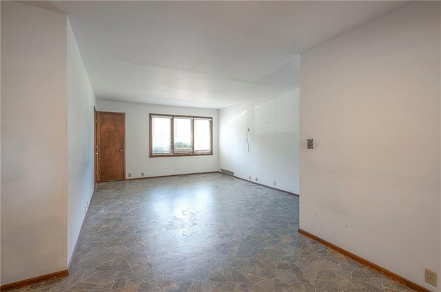462 W 104th St Unit A, Kansas City, MO 64114 - empty room featuring stone finish flooring and baseboards