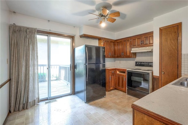 462 W 104th St Unit A, Kansas City, MO 64114 - kitchen featuring freestanding refrigerator, electric range oven, under cabinet range hood, brown cabinets, and ceiling fan