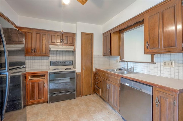 462 W 104th St Unit A, Kansas City, MO 64114 - kitchen with stainless steel dishwasher, electric range, fridge, and brown cabinets