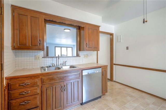 462 W 104th St Unit A, Kansas City, MO 64114 - kitchen with dishwasher, brown cabinetry, and tasteful backsplash