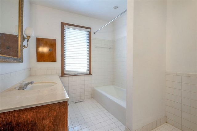 462 W 104th St Unit A, Kansas City, MO 64114 - full bath with tile walls, tile patterned flooring, vanity, and shower / tub combination