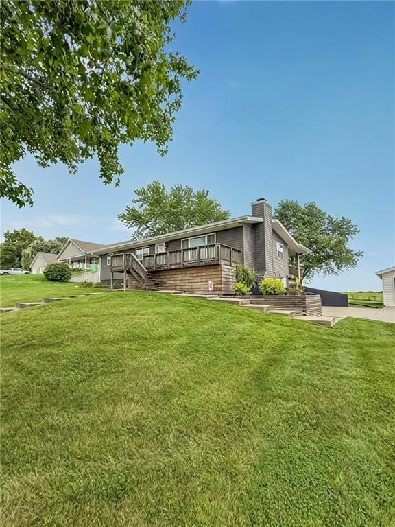 26240 Lakeview Dr, Maryville, MO 64468 - back of property featuring a chimney, a lawn, stairway, and a deck