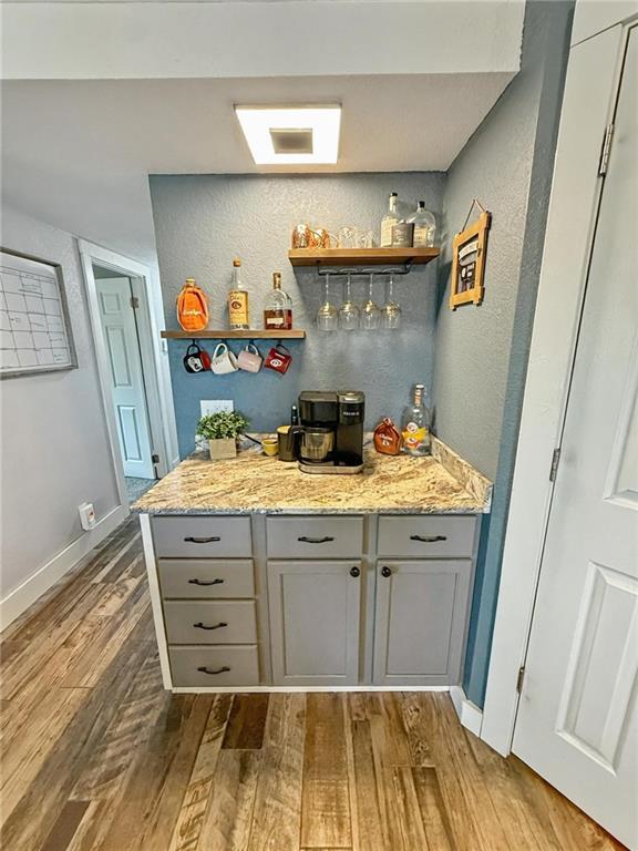 26240 Lakeview Dr, Maryville, MO 64468 - indoor dry bar with wood finished floors and a textured wall