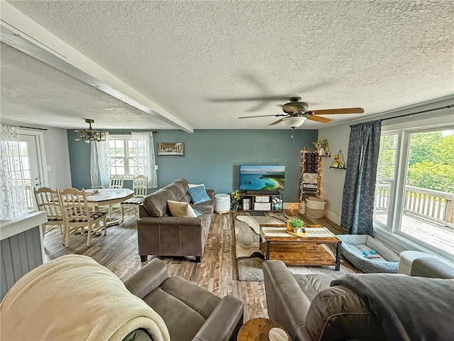 26240 Lakeview Dr, Maryville, MO 64468 - living area with wood finished floors, a textured ceiling, a chandelier, and ceiling fan