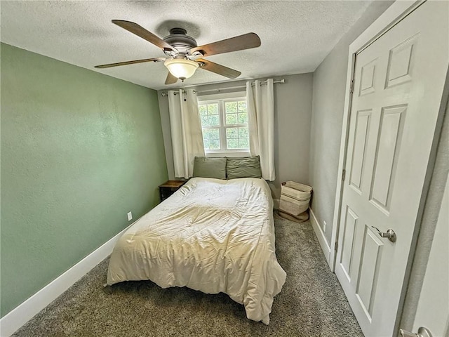 26240 Lakeview Dr, Maryville, MO 64468 - bedroom featuring dark carpet, a textured ceiling, and a ceiling fan
