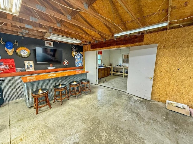 26240 Lakeview Dr, Maryville, MO 64468 - indoor dry bar with concrete flooring and vaulted ceiling