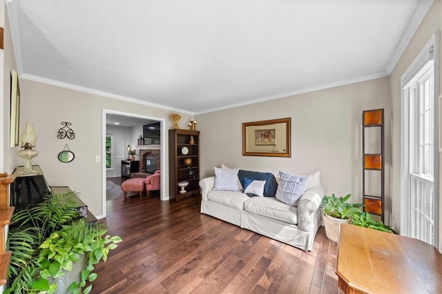 6710 Broadmoor St, Overland Park, KS 66204 - living area with wood-type flooring, a stone fireplace, and ornamental molding