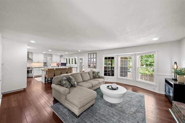6710 Broadmoor St, Overland Park, KS 66204 - living room featuring a textured ceiling, recessed lighting, and dark wood-style flooring