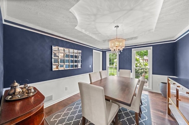 6710 Broadmoor St, Overland Park, KS 66204 - dining space featuring wood finished floors, a tray ceiling, a textured ceiling, a chandelier, and crown molding