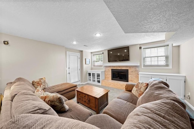 6710 Broadmoor St, Overland Park, KS 66204 - carpeted living area with a textured ceiling, a fireplace, and recessed lighting