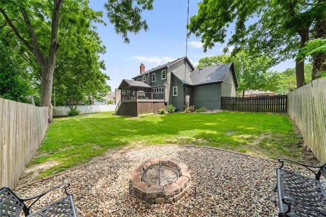 6710 Broadmoor St, Overland Park, KS 66204 - rear view of house with a fire pit, a fenced backyard, and a chimney