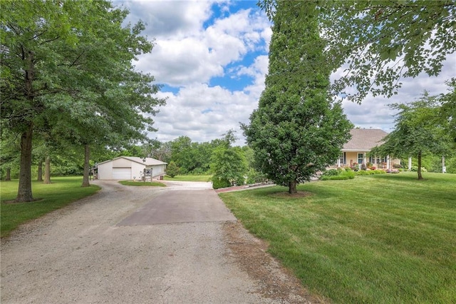 23708 S Southcrest Dr, Peculiar, MO 64078 - view of front of property featuring a front lawn, a garage, dirt driveway, and an outdoor structure