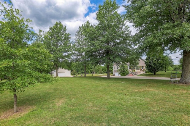 23708 S Southcrest Dr, Peculiar, MO 64078 - view of green lawn with a detached garage and an outdoor structure