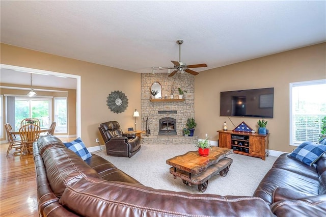 23708 S Southcrest Dr, Peculiar, MO 64078 - living area featuring a ceiling fan, a fireplace, and wood finished floors