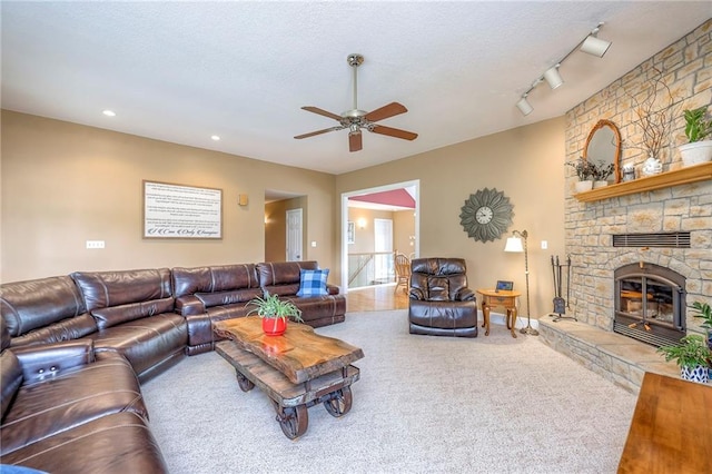 23708 S Southcrest Dr, Peculiar, MO 64078 - living room featuring ceiling fan, a fireplace, carpet floors, rail lighting, and a textured ceiling