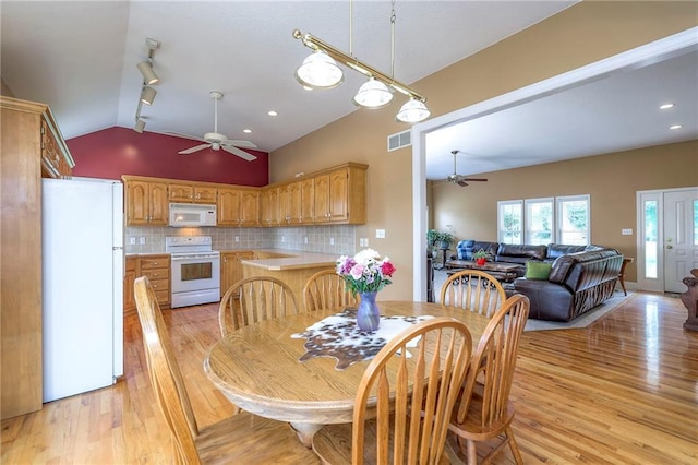 23708 S Southcrest Dr, Peculiar, MO 64078 - dining room with a ceiling fan, lofted ceiling, light wood-type flooring, track lighting, and recessed lighting