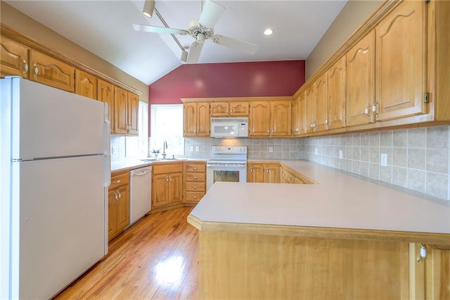 23708 S Southcrest Dr, Peculiar, MO 64078 - kitchen featuring white appliances, vaulted ceiling, light countertops, a peninsula, and a ceiling fan