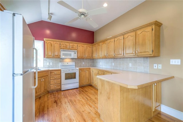 23708 S Southcrest Dr, Peculiar, MO 64078 - kitchen featuring white appliances, a peninsula, light wood-style floors, light countertops, and vaulted ceiling