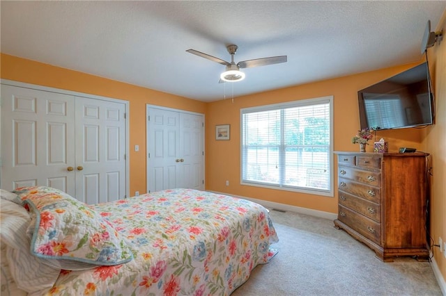 23708 S Southcrest Dr, Peculiar, MO 64078 - bedroom featuring multiple closets, light colored carpet, and ceiling fan