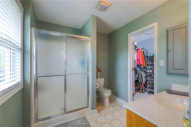 23708 S Southcrest Dr, Peculiar, MO 64078 - bathroom featuring a shower stall, vanity, a spacious closet, and tile patterned floors