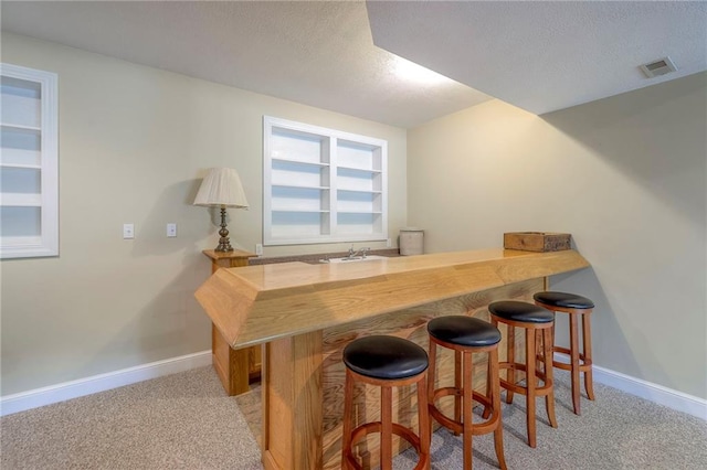23708 S Southcrest Dr, Peculiar, MO 64078 - indoor wet bar featuring a textured ceiling and light carpet