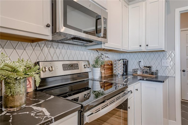 3323 N 109th Ter, Kansas City, KS 66109 - kitchen featuring stainless steel appliances, white cabinetry, backsplash, and dark countertops