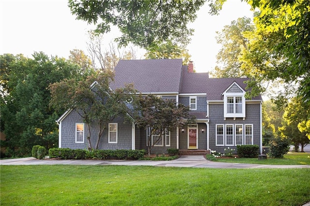 13009 Fontana St, Leawood, KS 66209 - view of front of property with a front yard and a chimney