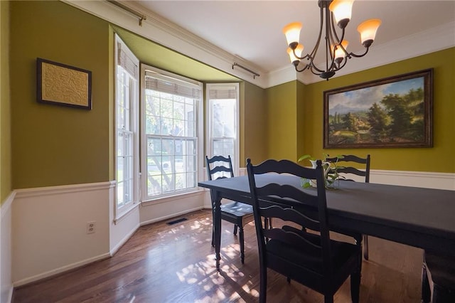 13009 Fontana St, Leawood, KS 66209 - dining area with a chandelier, wood finished floors, and ornamental molding