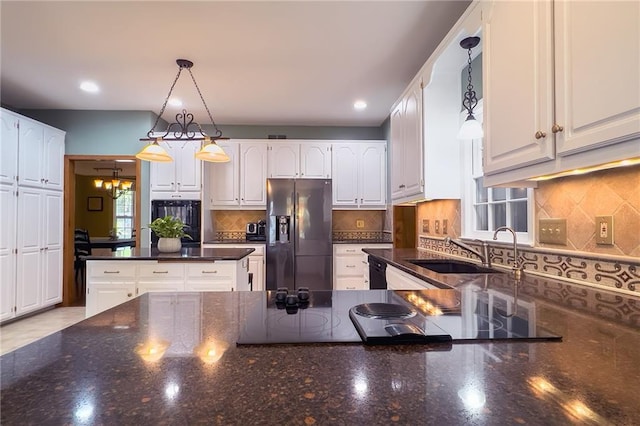 13009 Fontana St, Leawood, KS 66209 - kitchen with stainless steel fridge with ice dispenser, wall oven, dark stone countertops, white cabinetry, and recessed lighting