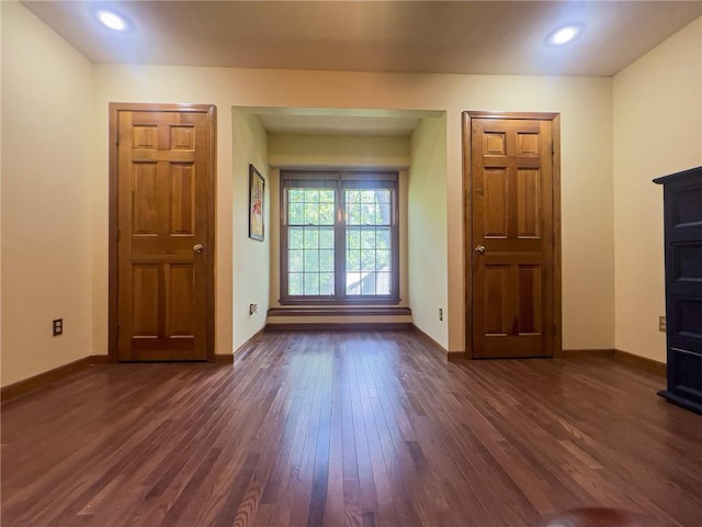 13009 Fontana St, Leawood, KS 66209 - unfurnished living room with dark wood-style flooring and baseboards