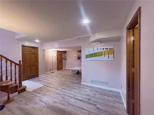 13009 Fontana St, Leawood, KS 66209 - foyer entrance with wood finished floors, stairs, a textured ceiling, and recessed lighting