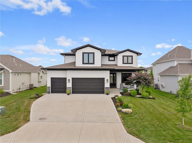 15297 W 172nd Pl, Olathe, KS 66062 - view of front of house featuring a front lawn, driveway, an attached garage, stone siding, and covered porch