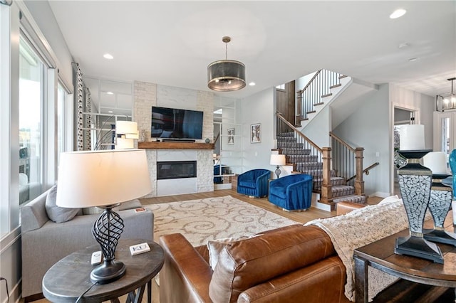 15297 W 172nd Pl, Olathe, KS 66062 - living room featuring wood finished floors, stairs, a fireplace, and recessed lighting