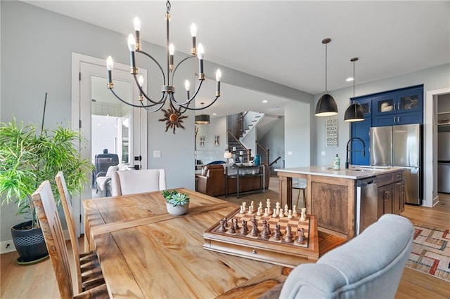 15297 W 172nd Pl, Olathe, KS 66062 - dining space featuring stairs, a chandelier, light wood finished floors, and recessed lighting
