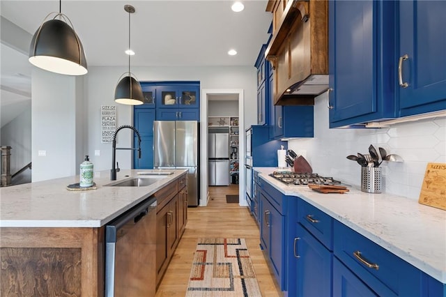 15297 W 172nd Pl, Olathe, KS 66062 - kitchen with stainless steel appliances, exhaust hood, blue cabinets, light wood-style floors, and recessed lighting