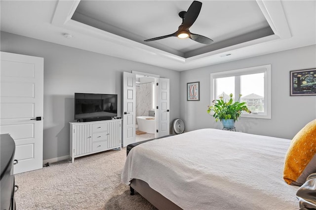 15297 W 172nd Pl, Olathe, KS 66062 - bedroom with a tray ceiling, carpet, ensuite bathroom, and ceiling fan